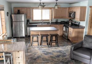 a kitchen with wooden cabinets and a counter top at Legacy Vacation Rental in Valemount +11 photos
