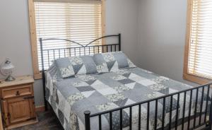 a bedroom with a bed with a quilt on it at Legacy Vacation Rental in Valemount