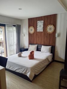 a bedroom with a bed with two stuffed animals on it at NEW KUBU DI BUKIT apartemen & motor bike rental in Jimbaran +18 photos