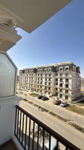 a balcony with a view of a large building at Crown Mountain in 6th Of October