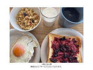 a table with a plate of breakfast food with an egg and toast at Togari Sunshine Lodge in Iiyama +4 photos
