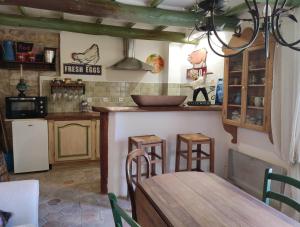 a kitchen with a table and a counter with chairs at La Janneto in Carpentras