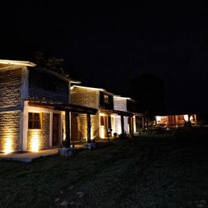 a house with lights on the side of it at night at Altépetl Cabañas Zacatlán in Tomatlán +2 photos