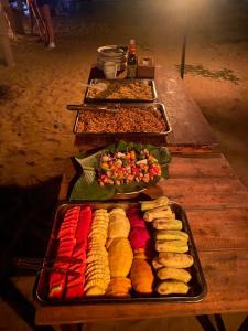 a buffet line with different types of food on trays at Lily's Beach Bungalows in Koh Rong Island +97 photos
