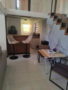 a room with a table and chairs and a kitchen at Optimum Apartments in Providence