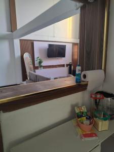 a mirror in a room with a bed and a table at Optimum Apartments in Providence