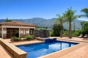 a swimming pool in front of a house at Hacienda Cascanueces in Villa de Leyva