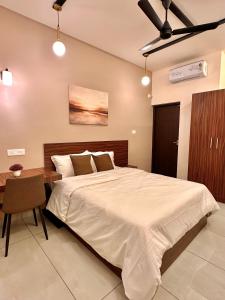 a bedroom with a large bed and a table at Global Residency in Kanjirapalli