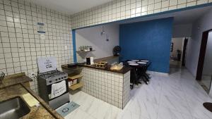 a kitchen with a stove and a table in it at Almar Hospedagem 2 ARRAIAL DO CABO in Arraial do Cabo +21 photos