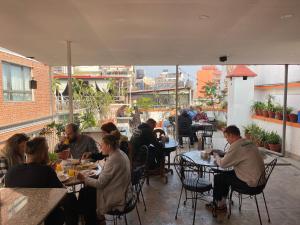 a group of people sitting at tables in a restaurant at Khangsar Home in Kathmandu