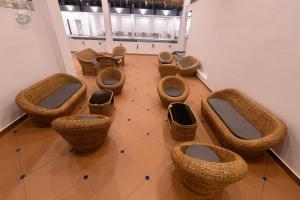 a group of wicker chairs and tables in a room at COUNTRYSIDE RESORT MURTi in Chālsa Mahābāri +10 photos