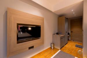 a living room with a large flat screen tv on the wall at COUNTRYSIDE RESORT MURTi in Chālsa Mahābāri