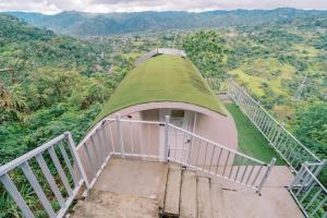 a building with a grassy roof with a staircase at Serenity Busay Room 8 in Cebu City