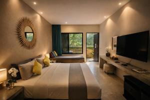 a bedroom with a large bed and a television at cooldowns resort maerim chiangmai in Ban Thung Pong