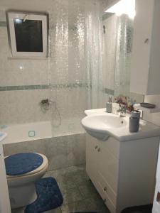 a bathroom with a toilet and a sink and a shower at Welcome studio in Preveza +8 photos