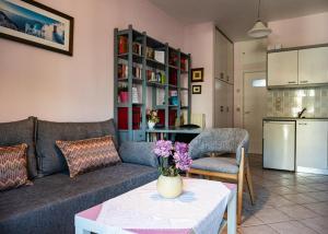 a living room with a couch and a table at Blue Petal Apartment, Relaxed Heraklion Stay in Amoudara Herakliou +11 photos