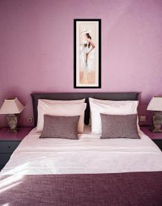 a bedroom with a large white bed with purple walls at Blue Petal Apartment, Relaxed Heraklion Stay in Amoudara Herakliou