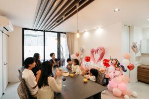a group of people sitting around a table with balloons at MIRATIO Umui Sauna&Spa in Onna +83 photos