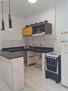 a small kitchen with a counter and a sink at Casa blue in Aracati