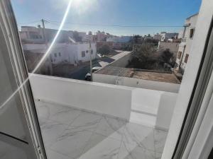 a balcony with a view of a city at Villa Prestige sfax in Sfax