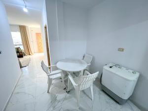 a room with a table and a small table and chairs at Villa Prestige sfax in Sfax