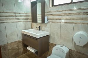 a bathroom with a sink and a toilet at Airport SJO Inn in Santiago Este +12 photos
