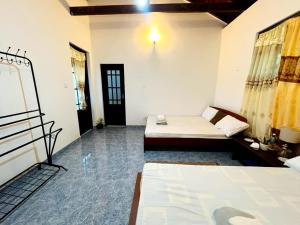 a room with two beds in a room at Village Breeze Villa in Haputale