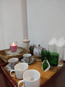 a table with cups and plates and candles on it at Sylvan Crest Ella in Ella