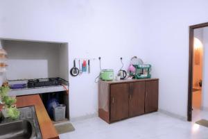 a kitchen with a sink and a stove top oven at Village Breeze Villa in Haputale