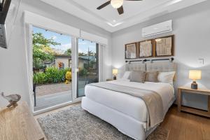 a bedroom with a bed and a large window at The Point 23 At Playa Avellanas in Playa Avellana +22 photos