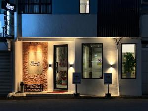 a store front with a bench in front of it at Muari Boutique Hotel in Muar