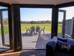 a screened in porch with a table and chairs at The Barley Silo in Ipswich