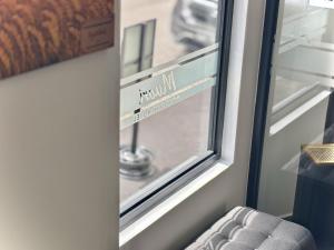 a window with a view of a street at Muari Boutique Hotel in Muar +65 photos
