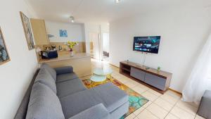 a living room with a couch and a tv at Noordhang Nest in Four Ways