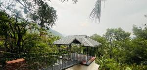 a gazebo in the middle of a forest at Eadhen Villa in Kudayattūr +36 photos