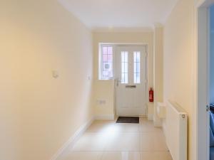a hallway with a white door and a tile floor at Dawson Park 6 - Uk12665 in Mablethorpe