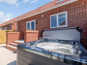 a large tub in front of a brick house at Dawson Park 6 - Uk12665 in Mablethorpe