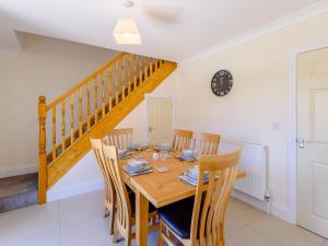 a dining room with a wooden table and chairs at Dawson Park 6 - Uk12665 in Mablethorpe