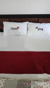 a bed with two pillows on top of it at Eadhen Villa in Kudayattūr