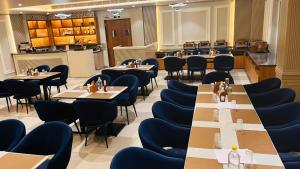 a dining room with tables and chairs at Hotel Eastleigh in Ludhiana