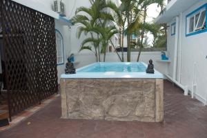a swimming pool with two statues on top of it at Villa Blue Marlin Iris in Blue Bay