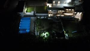 an overhead view of a swimming pool at night at Cozy Cliff By Marwar Royal in Thūr