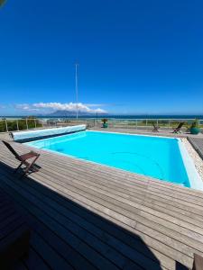 a swimming pool on top of a wooden deck at Sea Spray B103 in Cape Town