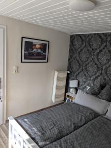 a bedroom with a bed and a picture on the wall at Eva's Home in Müllenbach