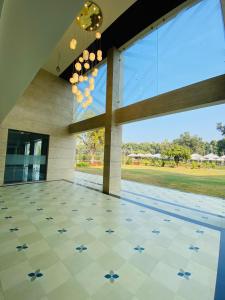 a lobby with a large window and a tiled floor at The Manak Bagh in Sehore