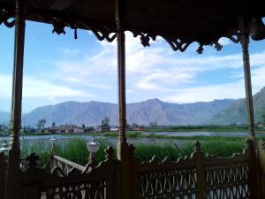 a view of a river and mountains from a porch at La Barca Zaindari in Srinagar