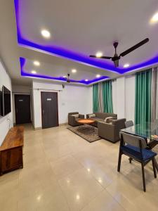 a living room with purple lights on the ceiling at Hotel serenity villa in Guwahati