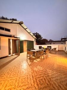 a patio with tables and chairs on top of a building at Hotel serenity villa in Guwahati