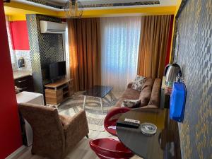 a living room with a couch and a table at Royal Palace Boutique Otel Boudja in Buca