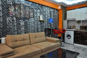 a living room with a couch and a kitchen at Royal Palace Boutique Otel Boudja in Buca